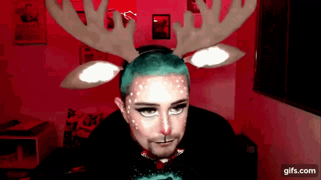a man with green hair and reindeer antlers