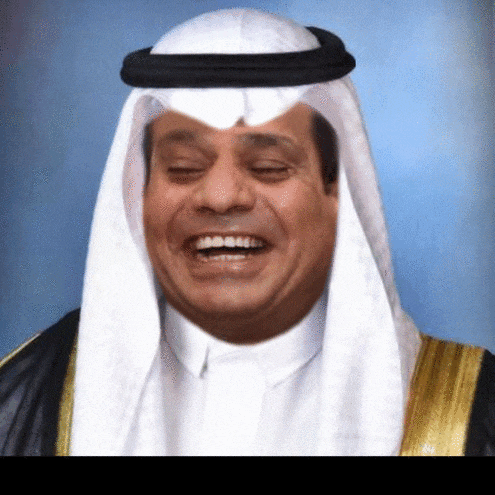 a man wearing a white robe and a black turban smiles