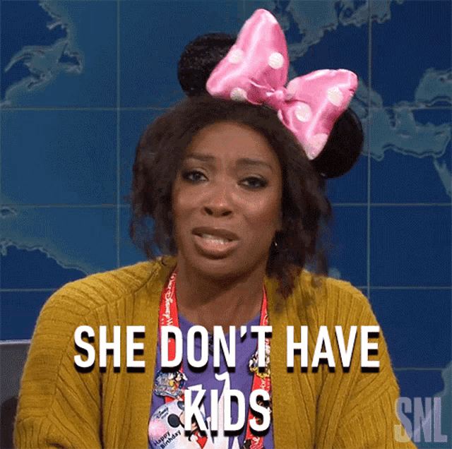 a woman with minnie mouse ears and a pink bow on her hair says she does n't have kids