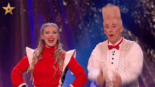 a man and a woman are standing on a stage with a star in the background