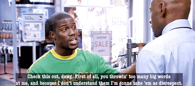 a man is talking to another man in front of a sale sign