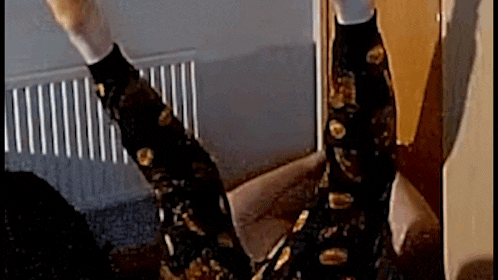 a person is laying on the floor with their legs up .
