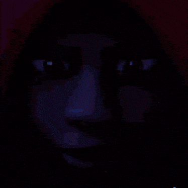 a blurry picture of a person in a dark room with blue lights