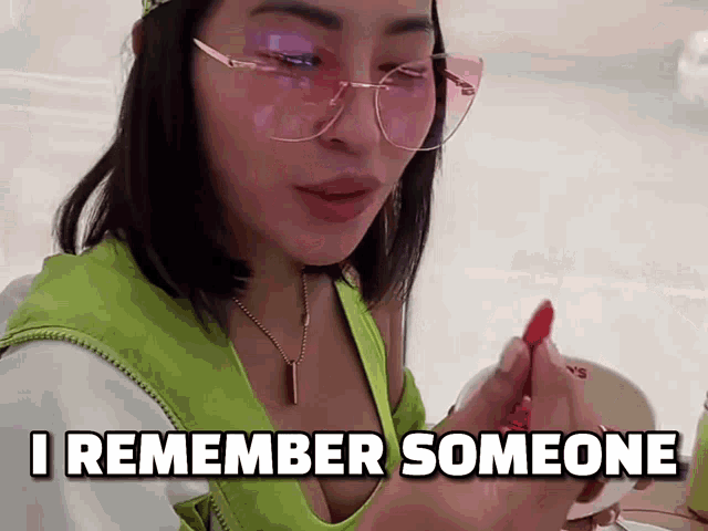 a woman wearing sunglasses and a green tank top says " i remember someone "