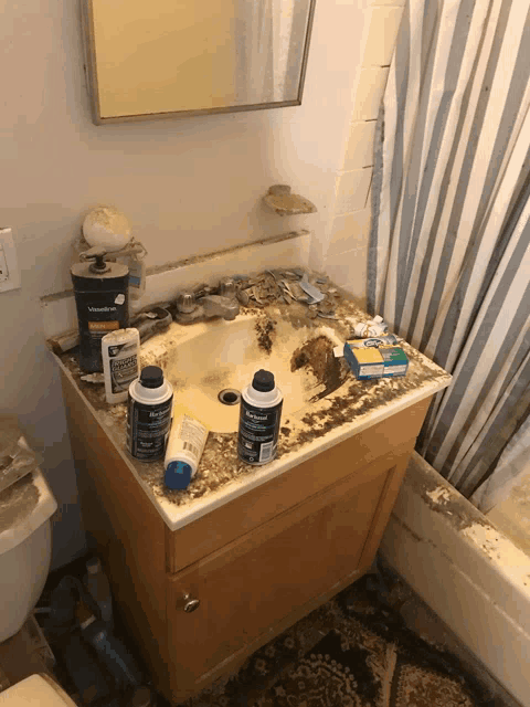 a bathroom with a sink that has a bottle of kleenex