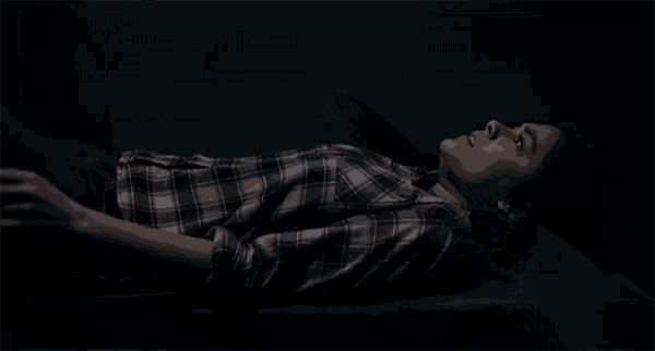a dark room with a sink and a ghost coming out of the walls .