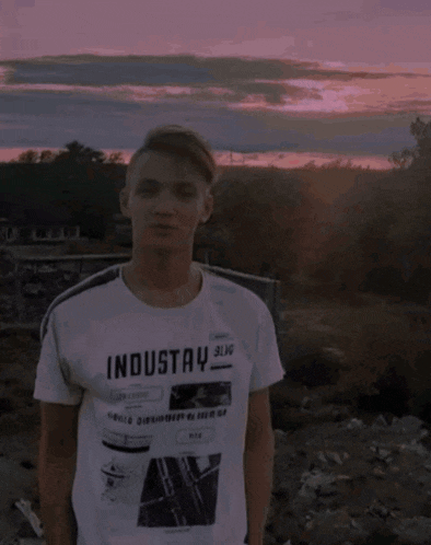 a young man wearing a white t-shirt that says industry sling