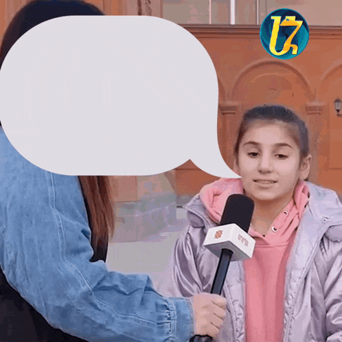 a girl is being interviewed by a woman with a speech bubble that says u7