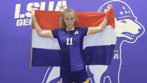 a girl with the number 11 on her shirt holds a flag