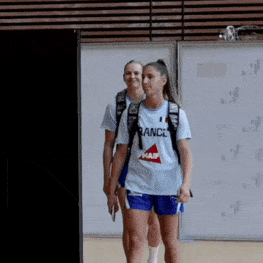 a woman wearing a france shirt and shorts