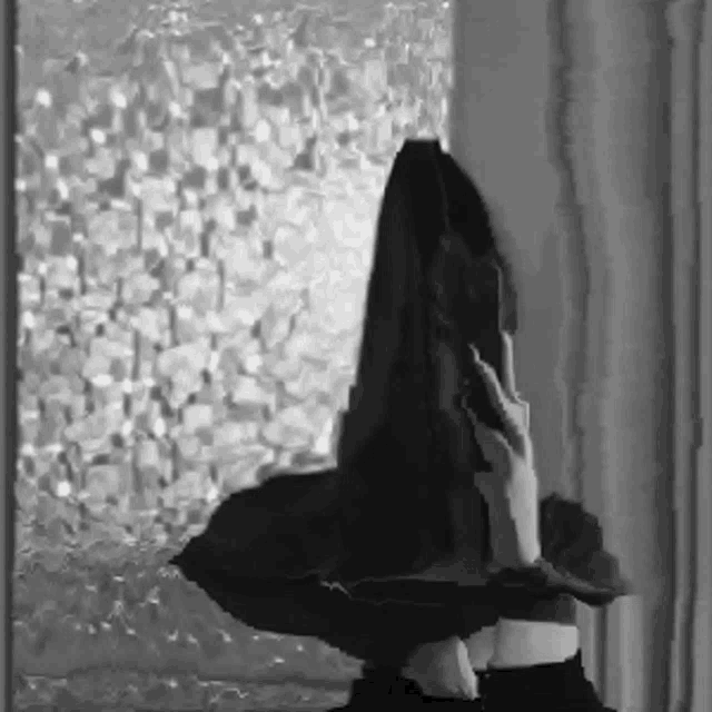 a black and white photo of a person holding a blanket
