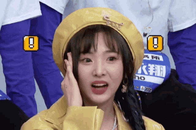a girl wearing a yellow beret and a yellow jacket has a sticker on her shirt that says ' no ' on it