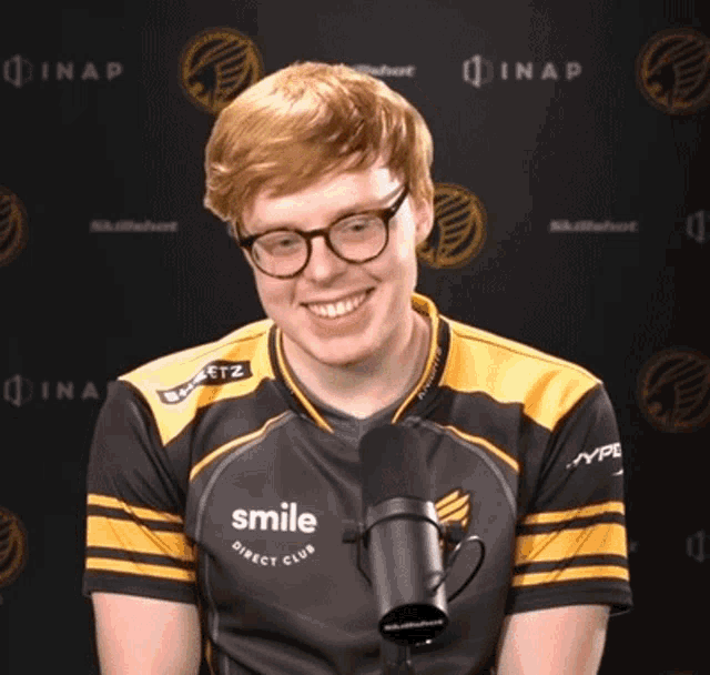 a man wearing glasses and a shirt that says smile direct club