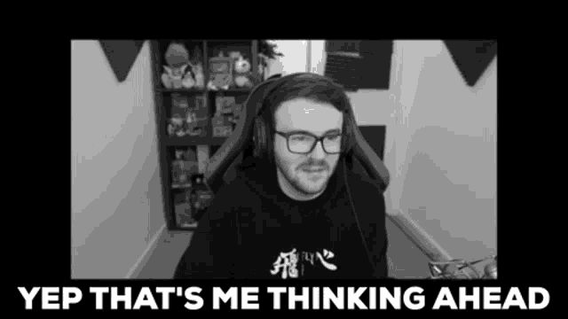 a black and white photo of a man wearing glasses and headphones with yep that 's me thinking ahead written below him
