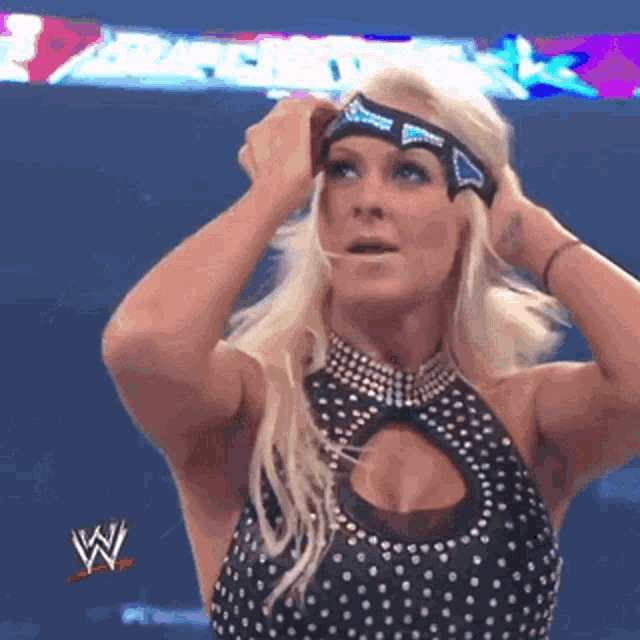 a female wrestler is wearing a headband with the letters w on it