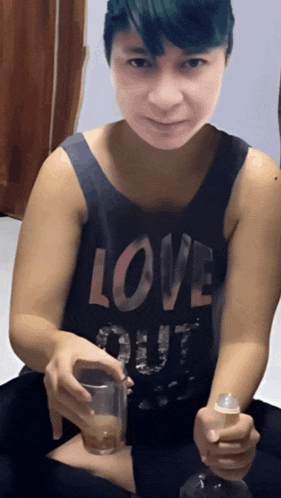 a woman wearing a black tank top with the word love on it