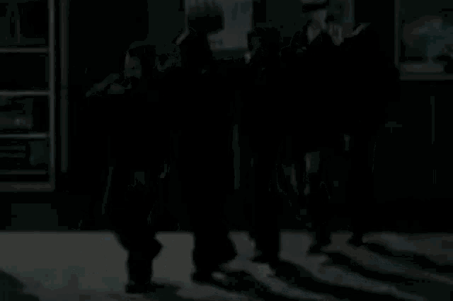 a group of people are standing next to each other in a room .