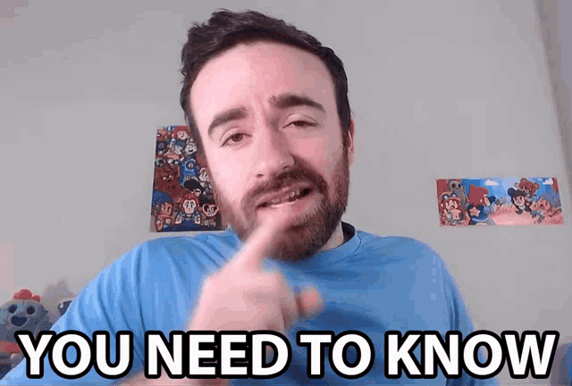 a man in a blue shirt says you need to know with his finger