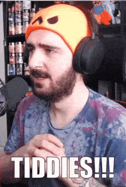 a man with a beard wearing headphones says tiddies !!!