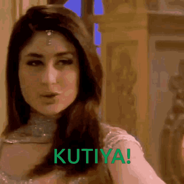 a close up of a woman 's face with the word kutiya written in green