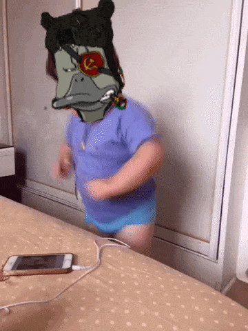 a child with a cartoon character on his head is standing on a bed