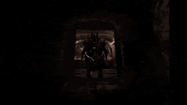 a very dark room with a few lights on