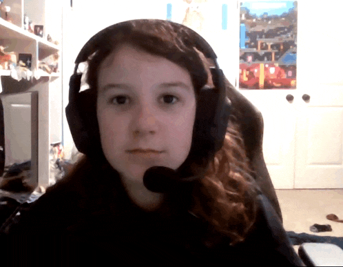 a girl wearing headphones and a microphone is sitting in front of a poster of a city