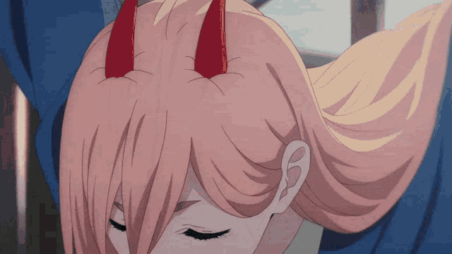 a close up of a girl 's hair with horns on it
