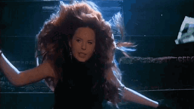 a woman with long red hair is floating in the air