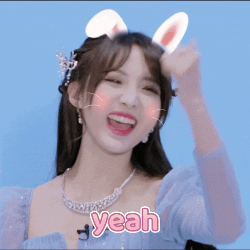 a girl with bunny ears on her head and the word yeah on her chest
