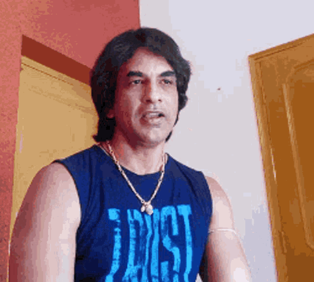 a man wearing a blue shirt that says " lost " on it
