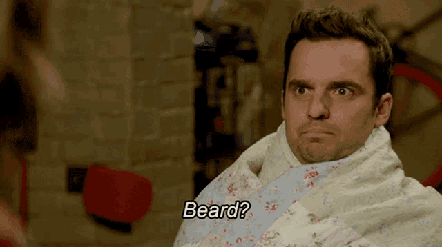 a man wrapped in a blanket with the word beard written on it