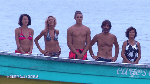 a group of people are standing in a boat that says carte 's on the side