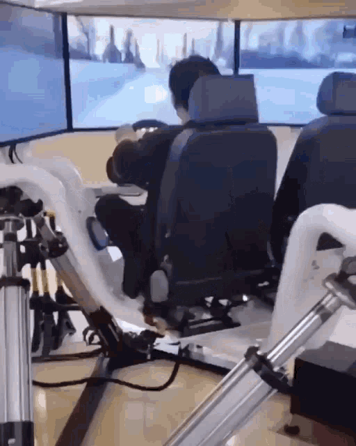 a man is sitting in a chair playing a game