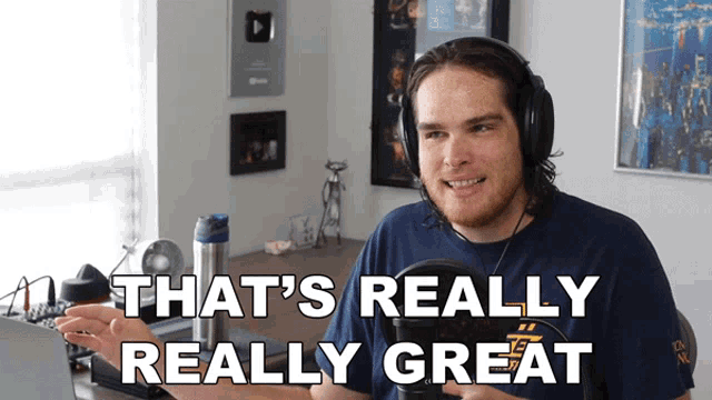 a man wearing headphones and a blue shirt says that 's really really great