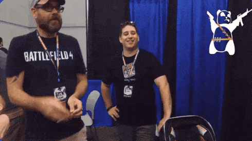 a man wearing a battlefield 4 t-shirt is standing next to another man