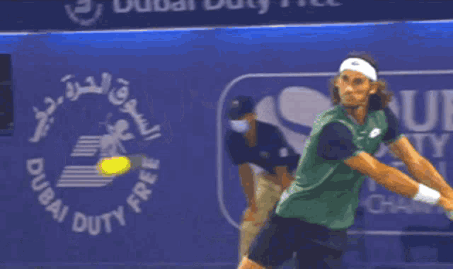 a dubai duty free sign is behind a tennis player