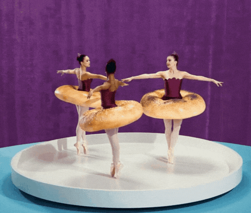 three ballerinas are dancing with bagel rings on their dresses