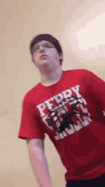 a man wearing a red shirt that says pfddy