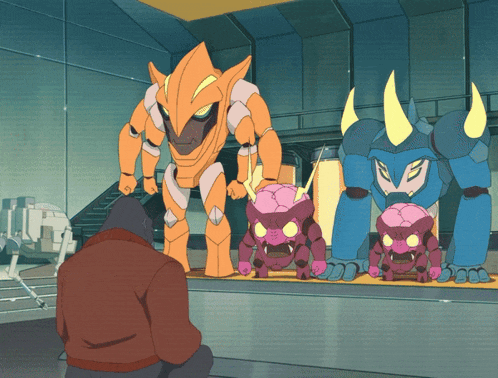 a man is looking at a group of robotic monsters