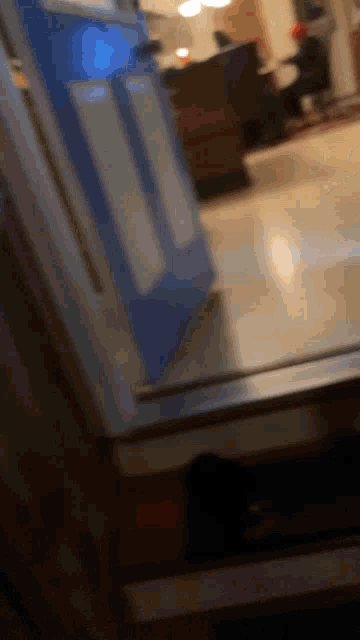 a blurry picture of a blue door in a room
