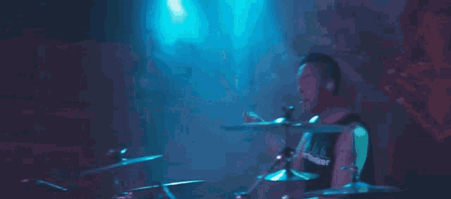 a man is playing drums with a shirt that says worthless