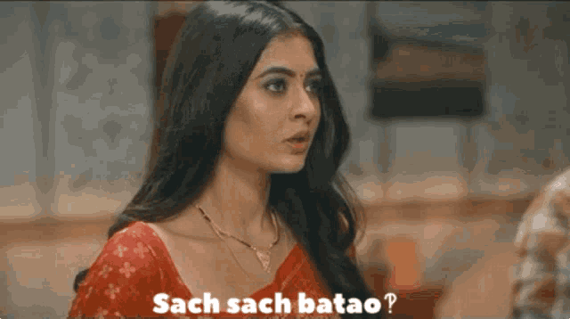 a woman in a red saree is asking sach sach batao