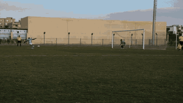 a soccer player in a blue jersey is kicking the ball