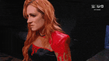 two women are standing next to each other and one is wearing a wrestling belt with the number 4 on it
