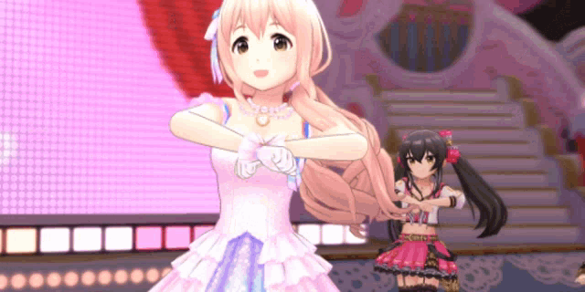 a girl in a pink dress is dancing on a stage with another girl