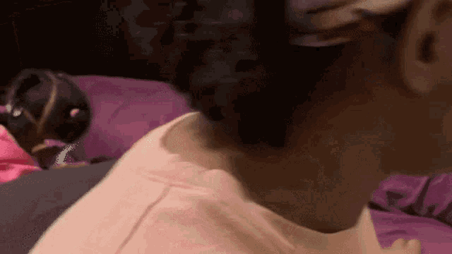 a close up of a woman 's neck and shoulder while a little girl looks on .