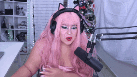 a woman with pink hair wearing headphones and cat ears