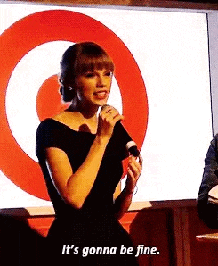 a woman is holding a microphone in front of a target logo and saying `` it 's gonna be fine '' .