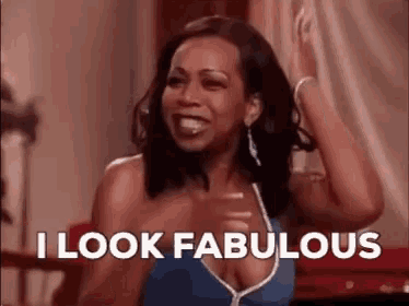 a woman in a blue dress is saying i look fabulous .